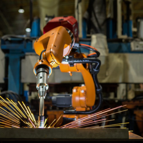 Robot is welding metal part in automotive industrial