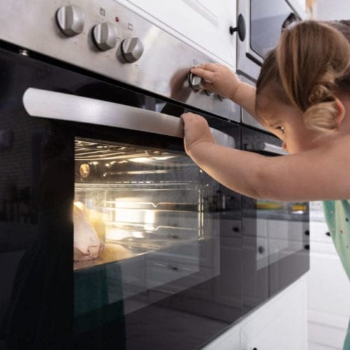 Girl looking at oven