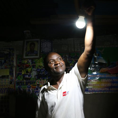 man looking at lightbulb