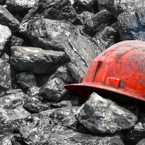 coal pile with worker's helmet