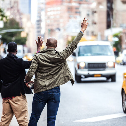 two men hailing a taxi