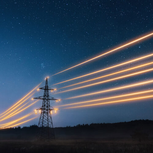 powerlines at night with glowing cables