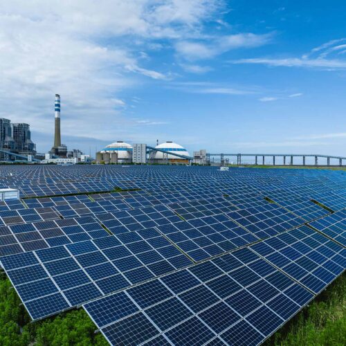 solar array field with factory in back